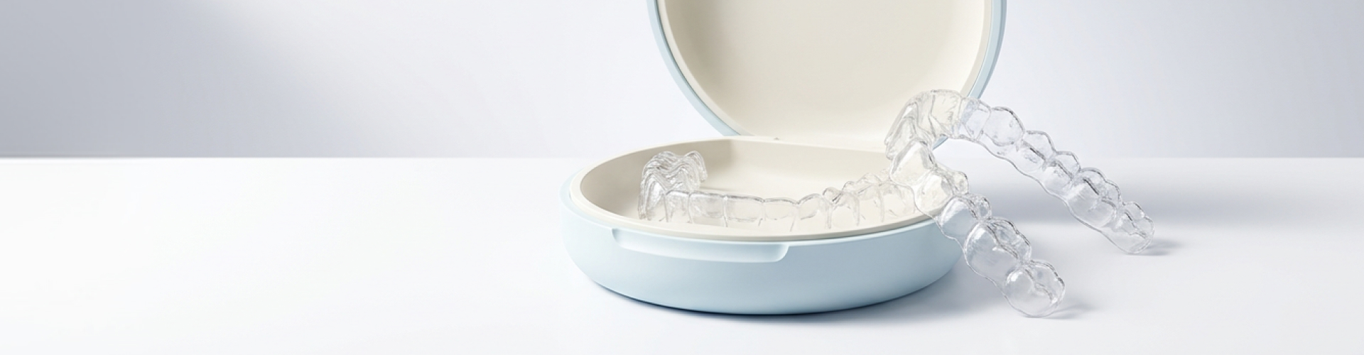 Clear aligner leaning on its case.